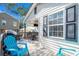 Outdoor deck featuring a dining set, grill, and comfortable blue lounge chairs at 6001 - N84 S Kings Hwy., Myrtle Beach, SC 29575
