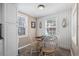 The dining area has wood trim detail, two bright windows, and a light fixture at 6001 - N84 S Kings Hwy., Myrtle Beach, SC 29575