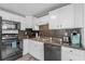 The kitchen features white cabinets, black appliances, and a decorative tile backsplash at 6001 - N84 S Kings Hwy., Myrtle Beach, SC 29575