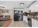 Bright kitchen offers white cabinets, black appliances, and seamless transition to the living space at 6001 - N84 S Kings Hwy., Myrtle Beach, SC 29575