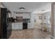 Bright kitchen with white cabinets, black appliances, decorative backsplash, and adjacent dining area at 6001 - N84 S Kings Hwy., Myrtle Beach, SC 29575