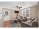 Comfortable living room features a neutral-toned sofa, ceiling fan, a mounted tv and an exterior door at 6001 - N84 S Kings Hwy., Myrtle Beach, SC 29575