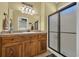 Bathroom features wooden cabinets, a large mirror with vanity lights, and a standing shower at 6001-O32 S Kings Hwy., Myrtle Beach, SC 29575