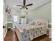 Bright bedroom with ceiling fan, hard wood floors, and palm tree bedding at 6001-O32 S Kings Hwy., Myrtle Beach, SC 29575