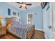 Light blue bedroom with a ceiling fan, window and comfortable bed at 6001-O32 S Kings Hwy., Myrtle Beach, SC 29575