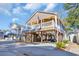 Attractive raised beach home, with a covered porch and golf cart parking below at 6001-O32 S Kings Hwy., Myrtle Beach, SC 29575
