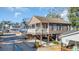 Attractive two-story beach house on pilings, complete with a cozy porch and convenient golf cart parking at 6001 - O32 S Kings Hwy., Myrtle Beach, SC 29575