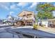Charming two-story home on pilings featuring a welcoming porch and lush tropical landscaping at 6001-O32 S Kings Hwy., Myrtle Beach, SC 29575