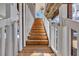 Exterior wooden staircase with white railings, leading to the upper level of this beautiful home at 6001-O32 S Kings Hwy., Myrtle Beach, SC 29575