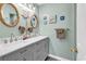 Bathroom with double sink vanity, rope trimmed mirrors, and nautical decorations at 602 Waterway Village Blvd. # 30-F, Myrtle Beach, SC 29579