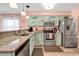 Charming kitchen featuring granite countertops, stainless steel appliances, and whimsical dolphin-themed cabinets at 602 Waterway Village Blvd. # 30-F, Myrtle Beach, SC 29579