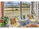 Enclosed porch with two wicker chairs and peaceful views of the outdoors at 602 Waterway Village Blvd. # 30-F, Myrtle Beach, SC 29579