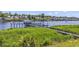 Scenic waterway with a private pier, boat lift and neighborhood in the distance at 602 Waterway Village Blvd. # 30-F, Myrtle Beach, SC 29579