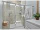 Bathroom featuring tiled shower with glass door, seat, and shower niche at 617 Cherry Blossom Dr., Murrells Inlet, SC 29576