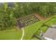Aerial view of a well-maintained community garden plot with wooden benches and walking path at 617 Cherry Blossom Dr., Murrells Inlet, SC 29576