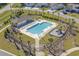 Aerial shot of a community pool with ample lounge chairs, shade, and a playground at 617 Cherry Blossom Dr., Murrells Inlet, SC 29576