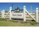 Welcoming Twin Oaks community entrance sign surrounded by lush landscaping under a bright blue sky at 617 Cherry Blossom Dr., Murrells Inlet, SC 29576