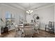 Bright dining room with a stylish chandelier, wood floors, and neutral décor at 617 Cherry Blossom Dr., Murrells Inlet, SC 29576