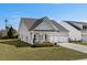 Well-maintained one-story home featuring a charming front porch and a two-car attached garage at 617 Cherry Blossom Dr., Murrells Inlet, SC 29576