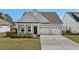 Charming single-Gathering home with a well-manicured lawn and an attached two-car garage at 617 Cherry Blossom Dr., Murrells Inlet, SC 29576