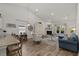 Open-concept living room with wood floors, a fireplace, and lots of natural light at 617 Cherry Blossom Dr., Murrells Inlet, SC 29576