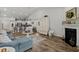Open floor plan living room with fireplace adjacent to kitchen, with hardwood style flooring at 617 Cherry Blossom Dr., Murrells Inlet, SC 29576
