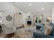 Bright living room featuring a fireplace, wood floors, blue couch and vaulted ceilings at 617 Cherry Blossom Dr., Murrells Inlet, SC 29576