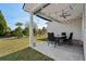 Covered patio with an outdoor dining set overlooking a well-maintained lawn at 617 Cherry Blossom Dr., Murrells Inlet, SC 29576