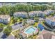 Aerial view of the condo complex featuring a pool, landscaping, and parking areas at 6253 Catalina Dr. # 921, North Myrtle Beach, SC 29582