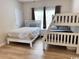 Bedroom featuring hardwood floors, a full sized bed, and a white bunk bed at 6253 Catalina Dr. # 921, North Myrtle Beach, SC 29582