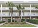 Inviting condo exterior with lovely, white balconies, brick accents, and meticulously maintained landscaping at 6253 Catalina Dr. # 921, North Myrtle Beach, SC 29582