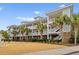 Multi-story condo building with tropical landscaping, balconies, and exterior staircases at 6253 Catalina Dr. # 921, North Myrtle Beach, SC 29582