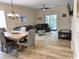 Open-concept living space with dining area, living room, patio access, and hardwood flooring at 6253 Catalina Dr. # 921, North Myrtle Beach, SC 29582