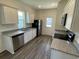 Modern kitchen with stainless steel appliances, granite countertops, white cabinets, and wood-look flooring at 627 Castillo Dr., Loris, SC 29569