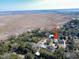 Aerial view of a charming home nestled among trees, with a river in the background at 632 Magnolia Dr., Georgetown, SC 29440