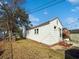 Back exterior view of a white house featuring brick foundation, green lawn and clear sky at 632 Magnolia Dr., Georgetown, SC 29440