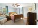 Comfortable bedroom featuring a wooden bed frame, light blue walls, and a cozy sitting area at 632 Magnolia Dr., Georgetown, SC 29440