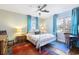 Bright bedroom with a metal bed frame, colorful rugs, and natural light from multiple windows at 632 Magnolia Dr., Georgetown, SC 29440