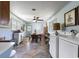 Cozy dining room featuring blue walls, a wooden table, tile floors, and adjacent laundry appliances at 632 Magnolia Dr., Georgetown, SC 29440