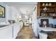Bright dining room showcasing a built-in desk and storage, leading into the kitchen with laundry area at 632 Magnolia Dr., Georgetown, SC 29440