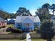 Charming cottage-style home with a metal roof, a picket fence, and a cozy front porch set against a clear blue sky at 632 Magnolia Dr., Georgetown, SC 29440
