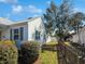 Side view of a white house with a green lawn and a wooden fence under a blue sky at 632 Magnolia Dr., Georgetown, SC 29440