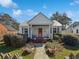 Charming house with a metal roof, a red front door, and a well-maintained front yard with a fence at 632 Magnolia Dr., Georgetown, SC 29440