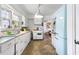 Bright kitchen showcasing white cabinetry and appliances, leading to the dining room at 632 Magnolia Dr., Georgetown, SC 29440