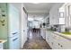Charming kitchen with a SMEG refrigerator, white cabinets, and a laundry area, all leading to the dining room at 632 Magnolia Dr., Georgetown, SC 29440