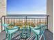 Inviting balcony with chairs, a small table, and stunning beach and ocean views at 6804 N Ocean Blvd. # 631, Myrtle Beach, SC 29572