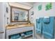 Bathroom featuring a granite countertop, decorative mirror and towels at 6804 N Ocean Blvd. # 631, Myrtle Beach, SC 29572