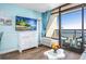 Comfortable living room with a TV, stylish cabinet, and balcony access with ocean views at 6804 N Ocean Blvd. # 631, Myrtle Beach, SC 29572