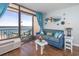 Relaxing living room with a blue sofa, sliding glass doors with ocean views, and bright decor at 6804 N Ocean Blvd. # 631, Myrtle Beach, SC 29572