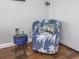 Cozy sitting area with a palm tree patterned chair and a small blue side table at 6804 N Ocean Blvd. # 631, Myrtle Beach, SC 29572